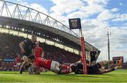 15 June 2024; Antoine Frisch of Munster scores his side's first try despite the efforts of Sebastian Cancelliere of Glasgow Warriors during the United Rugby Championship semi-final match between Munster and Glasgow Warriors at Thomond Park in Limerick. Photo by Brendan Moran/Sportsfile