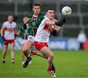 15 June 2024; Diarmuid Baker of Derry in action against John Heslin of Westmeath during the GAA Football All-Ireland Senior Championship Round 3 match between Derry and Westmeath at Páirc Esler in Newry, Down. Photo by Sam Barnes/Sportsfile