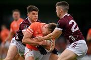 16 June 2024; Oisín O’Neill of Armagh is tackled by Tomo Culhane, left, and Johnny Heaney of Galway during the GAA Football All-Ireland Senior Championship Round 3 match between Armagh and Galway at Markievicz Park in Sligo. Photo by Brendan Moran/Sportsfile