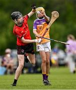 22 June 2024; Peter Jackman of Oulart The Ballagh, Wexford, in action against Alex Carrasco of Faythe Harriers, Wexford, during the John West Féile na nGael Camogie and Hurling Division One Finals at Hailo Tiles Wexford GAA Centre of Excellence in Ferns, Wexford.  Photo by Harry Murphy/Sportsfile