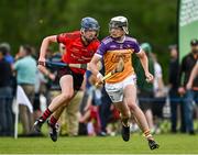22 June 2024; Oisín Caulfield of Faythe Harriers, Wexford, in action against Donnacha Proctor Laird of Oulart The Ballagh, Wexford, during the John West Féile na nGael Camogie and Hurling Division One Finals at Hailo Tiles Wexford GAA Centre of Excellence in Ferns, Wexford.  Photo by Harry Murphy/Sportsfile