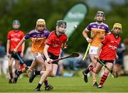 22 June 2024; Peter Jackman of Oulart The Ballagh, Wexford, in action against Alex Carrasco of Faythe Harriers, Wexford, during the John West Féile na nGael Camogie and Hurling Division One Finals at Hailo Tiles Wexford GAA Centre of Excellence in Ferns, Wexford.  Photo by Harry Murphy/Sportsfile