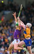 22 June 2024; Conor McDonald of Wexford in action against Adam Hogan of Clare during the GAA Hurling All-Ireland Senior Championship quarter-final match between Clare and Wexford at FBD Semple Stadium in Thurles, Tipperary. Photo by Ray McManus/Sportsfile