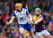 22 June 2024; Clare goalkeeper Eibhear Quilligan is tackled by Conor McDonald of Wexford during the GAA Hurling All-Ireland Senior Championship quarter-final match between Clare and Wexford at FBD Semple Stadium in Thurles, Tipperary. Photo by Ray McManus/Sportsfile