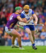 22 June 2024; Clare goalkeeper Eibhear Quilligan is tackled by Conor McDonald of Wexford during the GAA Hurling All-Ireland Senior Championship quarter-final match between Clare and Wexford at FBD Semple Stadium in Thurles, Tipperary. Photo by Ray McManus/Sportsfile