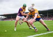 22 June 2024; Adam Hogan of Clare and Conor McDonald of Wexford fight for possession, near the end line, during the GAA Hurling All-Ireland Senior Championship quarter-final match between Clare and Wexford at FBD Semple Stadium in Thurles, Tipperary. Photo by Ray McManus/Sportsfile