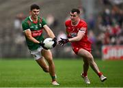 22 June 2024; Tommy Conroy of Mayo in action against Diarmuid Baker of Derry during the GAA Football All-Ireland Senior Championship preliminary quarter-final match between Mayo and Derry at Hastings Insurance MacHale Park in Castlebar, Mayo. Photo by Seb Daly/Sportsfile