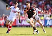 23 June 2024; Conor Grimes of Louth in action against Kevin Flahive of Cork during the GAA Football All-Ireland Senior Championship preliminary quarter-final match between Louth and Cork at Grattan Park in Inniskeen, Monaghan. Photo by Ben McShane/Sportsfile