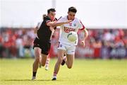 23 June 2024; Chris Óg Jones of Cork in action against Craig Lennon of Louth during the GAA Football All-Ireland Senior Championship preliminary quarter-final match between Louth and Cork at Grattan Park in Inniskeen, Monaghan. Photo by Ben McShane/Sportsfile