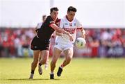23 June 2024; Chris Óg Jones of Cork in action against Craig Lennon of Louth during the GAA Football All-Ireland Senior Championship preliminary quarter-final match between Louth and Cork at Grattan Park in Inniskeen, Monaghan. Photo by Ben McShane/Sportsfile