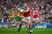 30 June 2024; Oisin Gallen of Donegal is tackled by Bevan Duffy of Louth during the GAA Football All-Ireland Senior Championship quarter-final match between Donegal and Louth at Croke Park in Dublin. Photo by Brendan Moran/Sportsfile