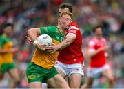30 June 2024; Oisin Gallen of Donegal is tackled by Bevan Duffy of Louth during the GAA Football All-Ireland Senior Championship quarter-final match between Donegal and Louth at Croke Park in Dublin. Photo by Brendan Moran/Sportsfile