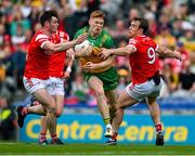 30 June 2024; Ciaran Moore of Donegal is tackled by Dan Corcoran and Bevan Duffy of Louth during the GAA Football All-Ireland Senior Championship quarter-final match between Donegal and Louth at Croke Park in Dublin. Photo by Brendan Moran/Sportsfile