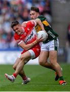 30 June 2024; Eunan Mulholland of Derry is tackled by Dara Moynihan of Kerry during the GAA Football All-Ireland Senior Championship quarter-final match between Kerry and Derry at Croke Park in Dublin. Photo by Shauna Clinton/Sportsfile