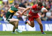 30 June 2024; Shane McGuigan of Derry is tackled by Jason Foley of Kerry during the GAA Football All-Ireland Senior Championship quarter-final match between Kerry and Derry at Croke Park in Dublin. Photo by Shauna Clinton/Sportsfile