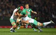 6 July 2024; Josh van der Flier of Ireland is tackled by Eben Etzebeth and Pieter-Steph du Toit of South Africa during the first test between South Africa and Ireland at Loftus Versfeld Stadium in Pretoria, South Africa. Photo by Brendan Moran/Sportsfile