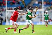 7 July 2024; Joseph McMullan, St Joseph's PS, Dunloy, Antrim, representing Limerick, in action against Jack Fitzpatrick, Sixmilebridge NS, Sixmilebridge, Clare, representing Cork, during the GAA INTO Cumann na mBunscol Respect Exhibition Go Games held before the GAA Hurling All-Ireland Senior Championship Semi-Final between Limerick and Cork at Croke Park in Dublin. Photo by Daire Brennan/Sportsfile