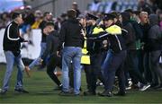 12 July 2024; Members of An Garda Síochána attempt to keep the peace as Drogheda United and Dundalk supporters fight at full-time of the SSE Airtricity Men's Premier Division match between Dundalk and Drogheda United at Oriel Park in Dundalk, Louth. Photo by Ben McShane/Sportsfile