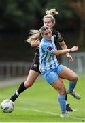13 July 2024; Katie Lawlee of Treaty United is tackled by Amber Cosgrove of DLR Waves during the SSE Airtricity Women's Premier Division match between DLR Waves and Treaty United at UCD Bowl in Belfield, Dublin. Photo by Thomas Flinkow/Sportsfile