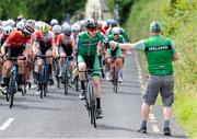 13 July 2024; Josh Callaly of Cycling Ireland team takes a water bottle during stage five of the 2024 Junior Tour of Ireland at the East Clare stage in Clare. Photo by Stephen McMahon/Sportsfile