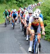 13 July 2024; Cameron Henry of Cycling Ulster team leads the peloton during stage five of the 2024 Junior Tour of Ireland at the East Clare stage in Clare. Photo by Stephen McMahon/Sportsfile