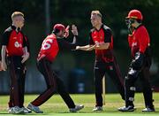 14 July 2024; Andrew Mullen of Strabane, second from right, celebrates with Ryan Gallagher, second from left, after taking the wicket of Ciaran Sheridan of North County during the Cricket Ireland National Cup semi-final match between North County and Strabane at The Inch Cricket Ground in Balrothery, Dublin. Photo by Sam Barnes/Sportsfile