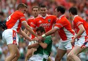 7 August 2004; Eamon Maguire, Fermanagh, is tackled by Armagh's, left to right, Philip Loughran, Andrew McCann, Aidan O'Rourke, and Andy Mallon. Bank of Ireland All-Ireland Senior Football Championship Quarter Final, Armagh v Fermanagh, Croke Park, Dublin. Picture credit; Pat Murphy / SPORTSFILE