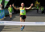 21 September 2013; Robbie Matthews, Dunshaughlin AC, crosses the finish line to win the half-marathon Airtricity Dublin race series. Phoenix Park, Dublin. Picture credit: Pat Murphy / SPORTSFILE