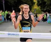 21 September 2013; Maria McCambridge crosses the finish line to win the half-marathon Airtricity Dublin race series. Phoenix Park, Dublin. Picture credit: Pat Murphy / SPORTSFILE