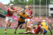 21 July 2024; Patrick Horgan of Cork is tackled by Adam Hogan of Clare as Brian Hayes of Cork looks on during the GAA Hurling All-Ireland Senior Championship Final between Clare and Cork at Croke Park in Dublin. Photo by John Sheridan/Sportsfile