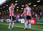 21 July 2024; Michael Duffy of Derry City, right, celebrates with teammate Ben Doherty and Cameron Dummigan, left, after scoring their side's third goal during the Sports Direct Men’s FAI Cup second round match between Derry City and St Patrick’s Athletic at the Ryan McBride Brandywell Stadium in Derry. Photo by Ben McShane/Sportsfile