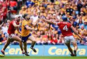 21 July 2024; Tony Kelly of Clare evades the tackle of Cork's Seán O'Donoghue on his way to scoring his side's third goal during the GAA Hurling All-Ireland Senior Championship Final match between Clare and Cork at Croke Park in Dublin. Photo by Seb Daly/Sportsfile