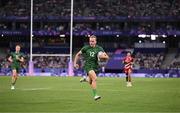 24 July 2024; Niall Comerford of Team Ireland on his way to scoring a try during the Men's Rugby Sevens Pool A match between Team Ireland and Team Japan at the Stade de France during the 2024 Paris Summer Olympic Games in Paris, France. Photo by Stephen McCarthy/Sportsfile