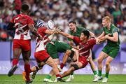 24 July 2024; Takamasa Maruo and Moeki Fukushi, left, of Team Japan is tackled by Team Ireland players, from left, Terry Kennedy, Andrew Smith of Team Ireland and Gavin Mullin during the Men's Rugby Sevens Pool A match between Team Ireland and Team Japan at the Stade de France during the 2024 Paris Summer Olympic Games in Paris, France. Photo by Stephen McCarthy/Sportsfile