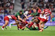 24 July 2024; Kippei Taninaka of Team Japan is tackled by Jack Kelly and Gavin Mullin of Team Ireland during the Men's Rugby Sevens Pool A match between Team Ireland and Team Japan at the Stade de France during the 2024 Paris Summer Olympic Games in Paris, France. Photo by Stephen McCarthy/Sportsfile