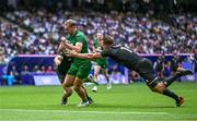 25 July 2024; Niall Comerford of Team Ireland is tackled by Scott Curry of Team New Zealand during the Men's Rugby Sevens Pool A match between Team Ireland and Team New Zealand at the Stade de France during the 2024 Paris Summer Olympic Games in Paris, France. Photo by Brendan Moran/Sportsfile