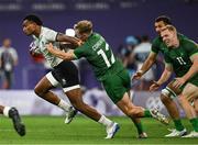 25 July 2024; Iosefo Baleiwairiki of Team Fiji evades the tackle of Niall Comerford of Team Ireland on his way to scoring the opening try during the Men's Rugby Sevens Quarter-Final match between Team Fiji and Team Ireland at the Stade de France during the 2024 Paris Summer Olympic Games in Paris, France. Photo by Brendan Moran/Sportsfile