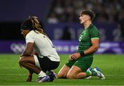 25 July 2024; Chay Mullins of Team Ireland and Selesitino Ravutaumada of Team Fiji at the final whistle of the Men's Rugby Sevens Quarter-Final match between Team Fiji and Team Ireland at the Stade de France during the 2024 Paris Summer Olympic Games in Paris, France. Photo by Brendan Moran/Sportsfile