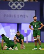 25 July 2024; Team Ireland players, from left, Andrew Smith, Terry Kennedy and Harry McNulty after defeat in the Men's Rugby Sevens Quarter-Final match between Team Fiji and Team Ireland at the Stade de France during the 2024 Paris Summer Olympic Games in Paris, France. Photo by Brendan Moran/Sportsfile