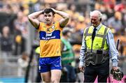 21 July 2024; Clare captain Tony Kelly makes his way to the Hogn Stand to accept the Liam MacCarthy Cup as Croke Park team steward Tom Ryan minds his helmet and hurl for him after the GAA Hurling All-Ireland Senior Championship Final between Clare and Cork at Croke Park in Dublin. Photo by Piaras Ó Mídheach/Sportsfile