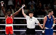 28 July 2024; Aidan Walsh of Team Ireland, right, reacts as referee Jongjin Kim announces Makan Traore of Team France as the winner after their men's 71kg preliminary round of 32 bout at the North Paris Arena during the 2024 Paris Summer Olympic Games in Paris, France. Photo by David Fitzgerald/Sportsfile
