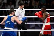 28 July 2024; Aidan Walsh of Team Ireland, left, and Makan Traore of Team France are watched by referee Jongjin Kim in their men's 71kg preliminary round of 32 bout at the North Paris Arena during the 2024 Paris Summer Olympic Games in Paris, France. Photo by David Fitzgerald/Sportsfile