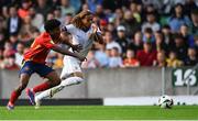 28 July 2024; Saimon Nadélia Bouabré of France in action against Cristian Perea of Spain during the UEFA European U19 Championship finals match between Spain and France at the National Football Stadium at Windsor Park, Belfast. Photo by Shauna Clinton/Sportsfile
