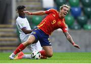 28 July 2024; Iker Bravo of Spain is tackled by Jérémy Jacquet of France during the UEFA European U19 Championship finals match between Spain and France at the National Football Stadium at Windsor Park, Belfast. Photo by Shauna Clinton/Sportsfile