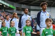 28 July 2024; France players, including Saimon Nadélia Bouabré, second from left, walk out with mascots before the UEFA European U19 Championship finals match between Spain and France at the National Football Stadium at Windsor Park, Belfast. Photo by Shauna Clinton/Sportsfile