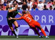 28 July 2024; Béibhinn Parsons of Team Ireland is tackled by Ellie Boatman of Team Great Britain during the Women's Rugby Sevens Pool B match between Team Ireland and Team Great Britain at the Stade de France during the 2024 Paris Summer Olympic Games in Paris, France.Photo by Hugo Pfeiffer/Sportsfile