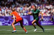 28 July 2024; Béibhinn Parsons of Team Ireland in action against Emma Uren of Team Great Britain during the Women's Rugby Sevens Pool B match between Team Ireland and Team Great Britain at the Stade de France during the 2024 Paris Summer Olympic Games in Paris, France.Photo by Hugo Pfeiffer/Sportsfile
