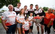 29 July 2024; Armagh players, from left, Ben Crealey, Paddy Burns, Jarly Óg Burns and Tiernan Kelly, with the McKee family, with 4 month old Faé in the Sam Maguire cup during the All-Ireland Football Champions visit to the Craigavon Area Hospital in Portadown, Armagh. Photo by Ramsey Cardy/Sportsfile