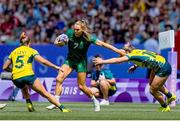 29 July 2024; Beibhinn Parsons of Team Ireland in action against Teagan Levi, left, and Isabella Nasser of Team Austalia during the Women's Rugby Sevens Pool B match between Team Ireland and Team Australia at the Stade de France during the 2024 Paris Summer Olympic Games in Paris, France. Photo by Hugo Pfeiffer/Sportsfile