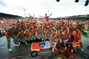29 July 2024; Armagh players and backroom staff celebrate on stage with the Sam Maguire Cup at the homecoming celebrations of the All-Ireland Senior Football Champions at BOX-IT Athletic Grounds in Armagh. Photo by Ramsey Cardy/Sportsfile